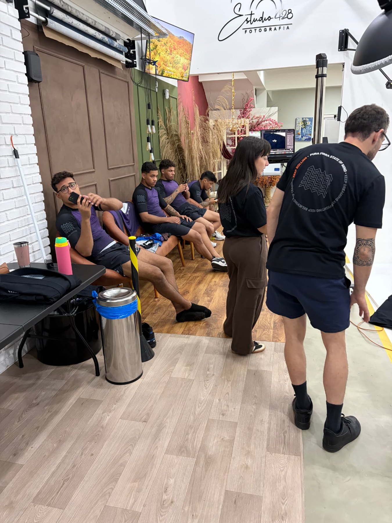 Camila working in the Pura Fibra photography studio with athletes behind her