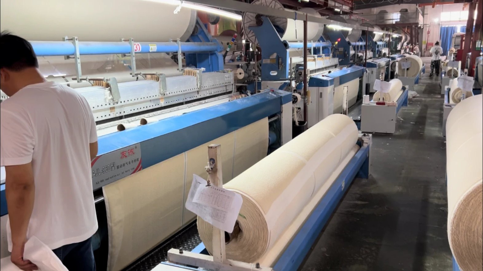 Industrial weaving machinery producing fabric