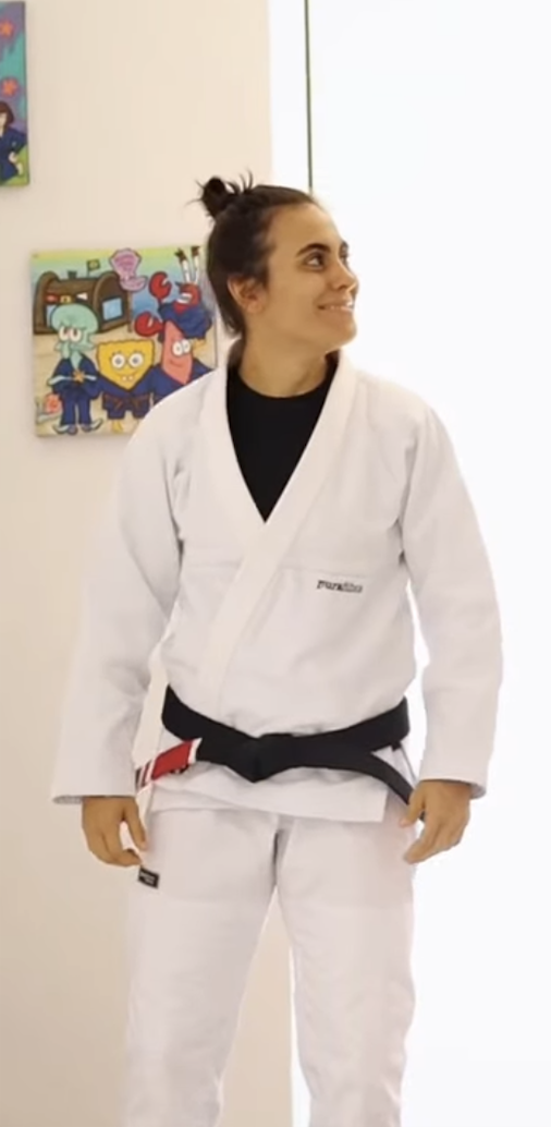 Tania smiling in a white gi