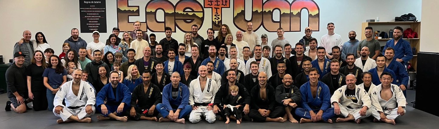 Walter surrounded by Alliance Vancouver students at Luke’s black belt promotion