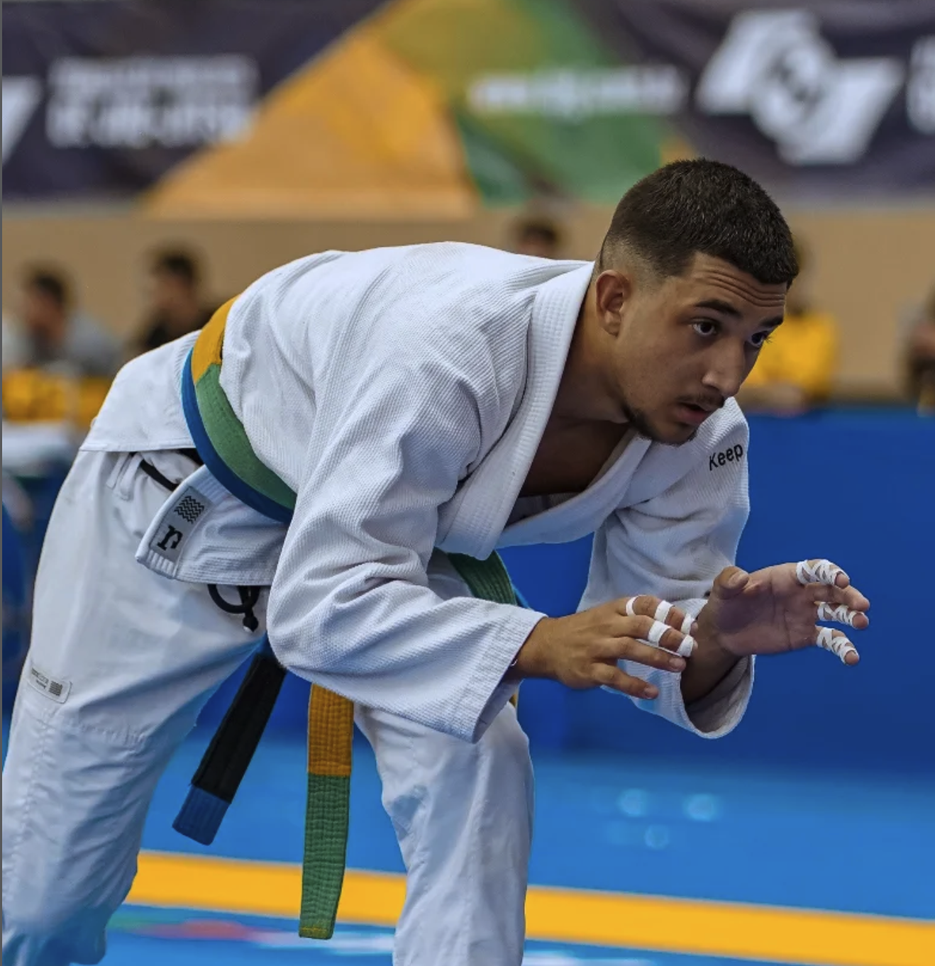 Felipe competing in a white gi at a tournament