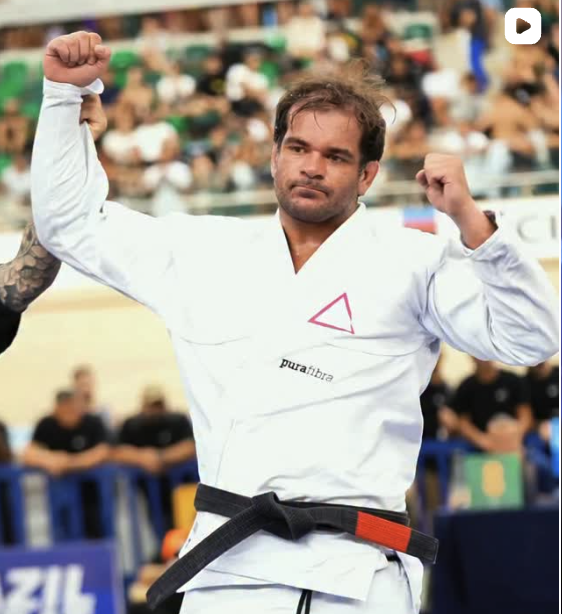 João celebrating a win with his hand raised